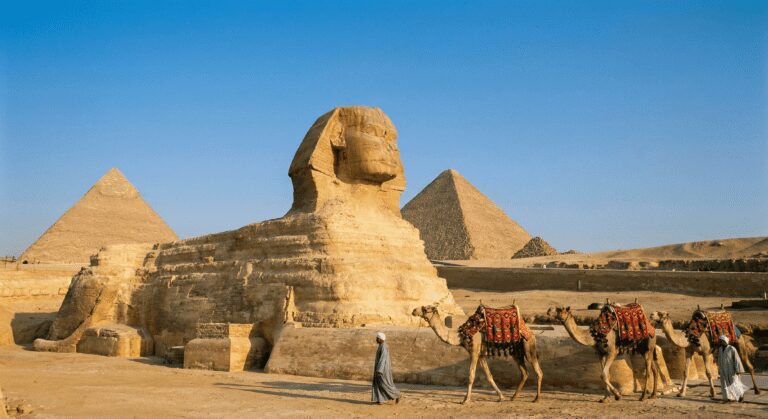 The Great Sphinx and Pyramids of Giza under a blue sky during a Cairo city tour from Hurghada.