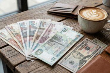 Egyptian Pound banknotes and US Dollars, illustrating currency exchange and money tips for tourists in Hurghada.